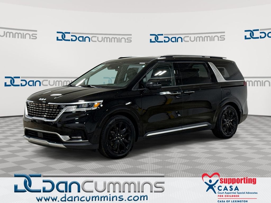 2022 Kia Carnival SX in Aurora Black — front three-quarter view