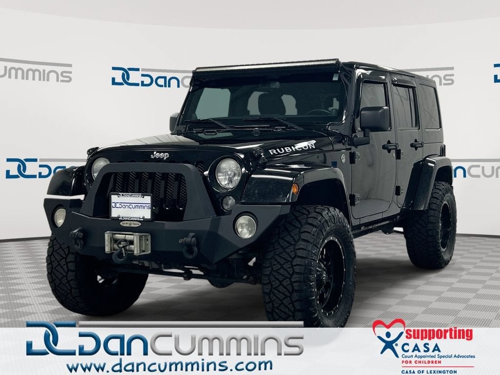 2014 Jeep Wrangler Unlimited Rubicon in Black — front three-quarter view