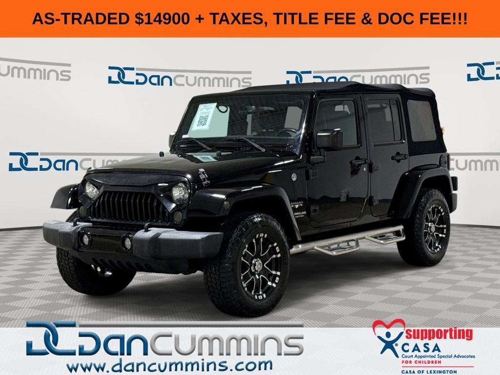 2016 Jeep Wrangler Unlimited Sahara in Black — front three-quarter view
